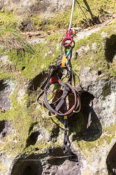 harness is prepared for climbing in Saxon Switzerland (Lilienstein mountain), Koenigstein, Germany