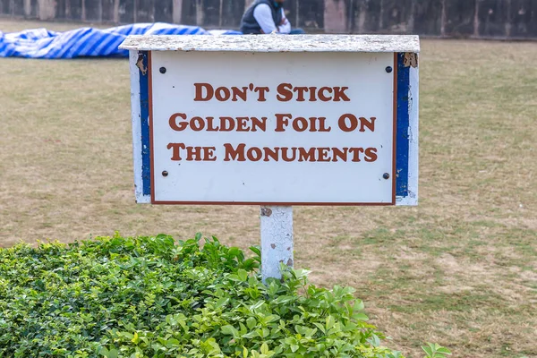 Text: Don\'s Stick Golden Foil On The Monuments, information sign for visitors in Sarnath, Varanasi, Uttar Pradesh, India
