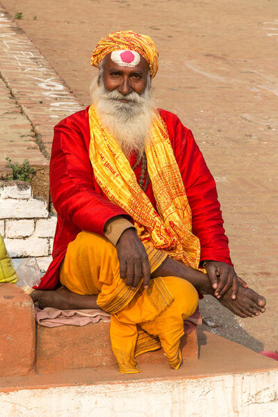 Varanasi, Uttar Pradesh, India - 12.15.2017; religious ascetic posing for visitors at the ghats