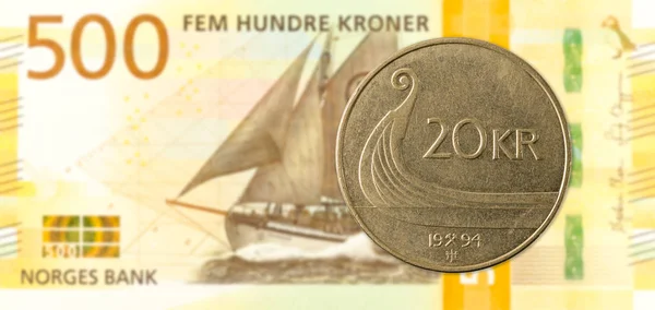 20 norwegian krone coin against 500 new norwegian krone banknote