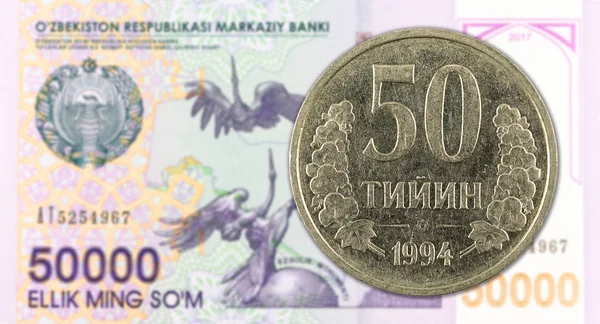 50 Uzbek Tiyin coin against 50000 Uzbek Som banknote — Stock Photo, Image