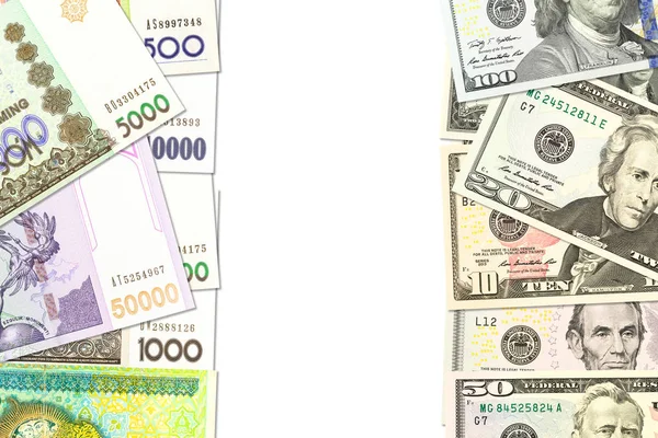Некоторые узбекские банкноты Сома и купюры в долларах США, указывающие на белу — стоковое фото