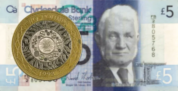 2 Pounds coin against 5 Pounds Sterling note issued by Clydesdal