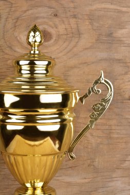 Ahşap arka plan karşı Boş altın kupa kupa