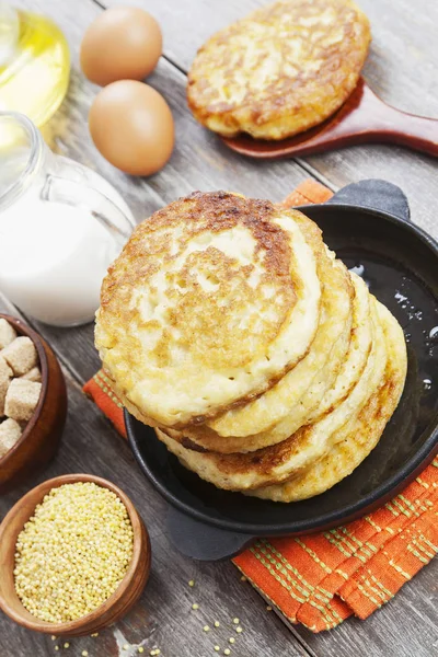 Millet pancakes in a frying pan — Stock Photo, Image