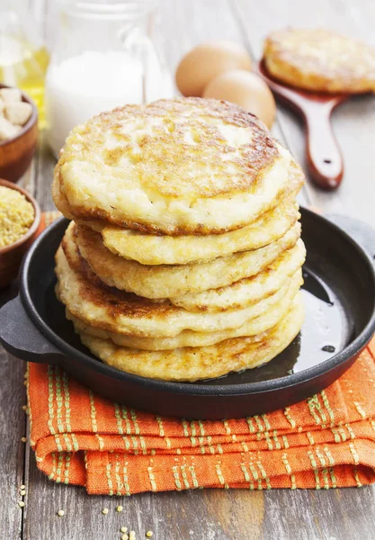 Millet pancakes in a frying pan — Stock Photo, Image