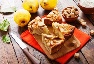 Fruit pie with quince on the table clipart