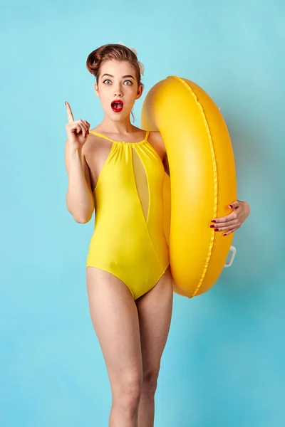 Blonde in a bathing suit and with an inflatable circle — Stock Photo, Image