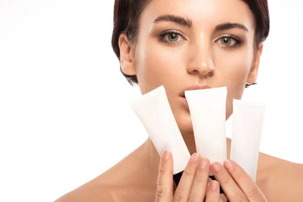 Beautiful brunette with short hair uses facial skin care products — Stock Photo, Image