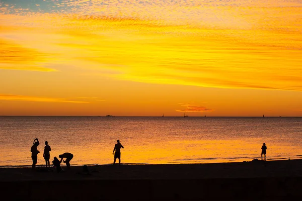 Landscape of silhouettes persons orange colors and contrast