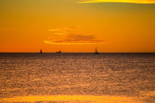 Landscape of silhouettes persons orange colors and contrast