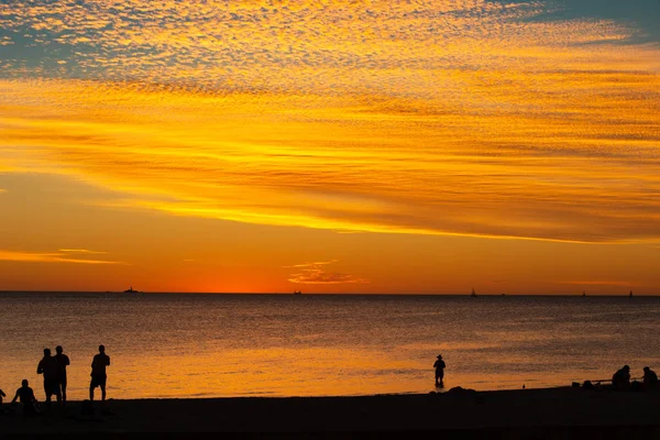 Landscape of silhouettes persons orange colors and contrast