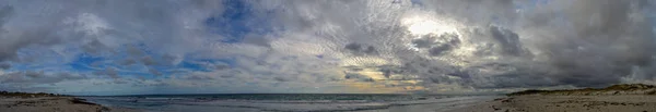 Panoramic landscape of the ocean and the sky full of clouds