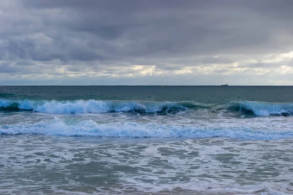 Landscape of a beach in north perth in a windy day full of waves water