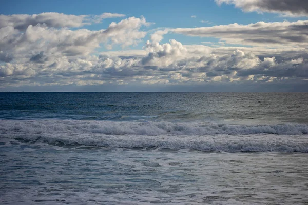 Landscape of a beach in north perth in a windy day full of waves water