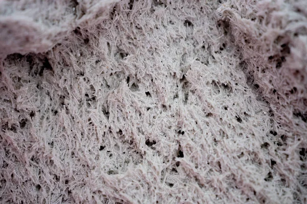 frozen liquid wallpaper similar to a snow mountain. Pink color. Porous structure.