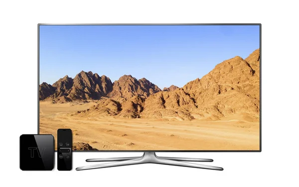 Smart tv and multimedia box with remote controller and mountain landscape wallpaper on screen. TV isolated on white background.