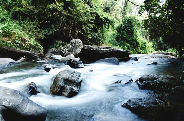 The stream flows from the waterfall.