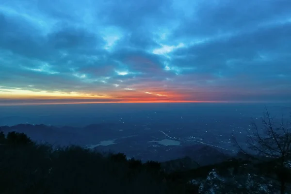 Sunrise view of mount tai.Tai 'an, China - winter 2017: a view from the top of mount tai.The direction of the mountains.The morning glow of sunrise.Clouds surge, colorful clouds at sunrise.The sunrise on the horizon.Overlooking the city and the lake