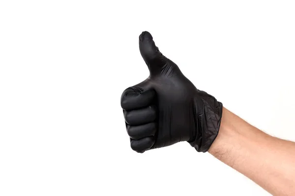 将手放在白色背景上的黑色橡胶手套中 手势拇指向上或像 外科医生或清洁的厨师成功工作的概念 — 图库照片