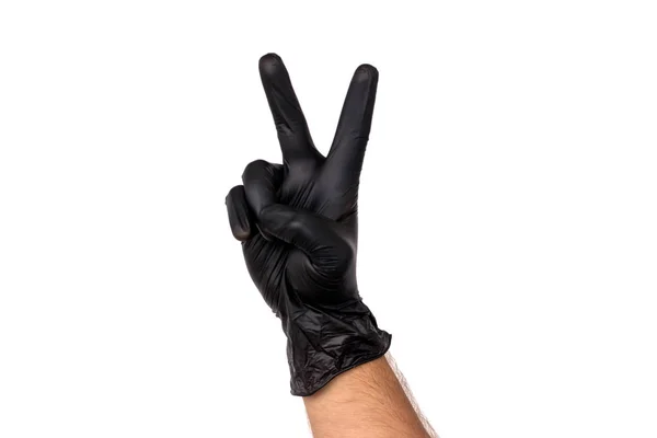 在白色背景上 用黑色橡胶手套把两个手指隔开 胜利的手势 外科医生或清洁的厨师成功工作的概念 — 图库照片