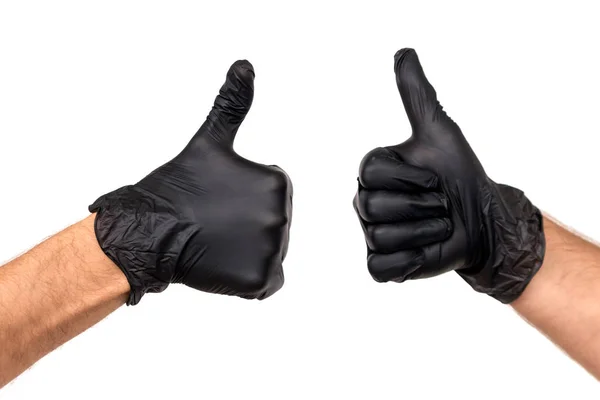 将手放在白色背景上的黑色橡胶手套中 手势拇指向上或像 外科医生或清洁的厨师成功工作的概念 — 图库照片