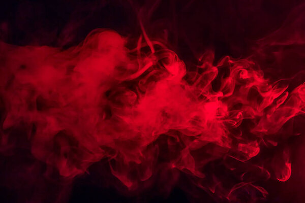 Colorful smoke on a black background of red and white colors. Beautiful textural background