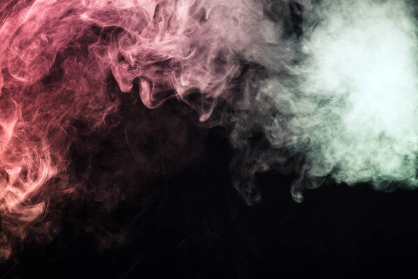 Colored smoke on a black background. The concept of a light show at a music concert