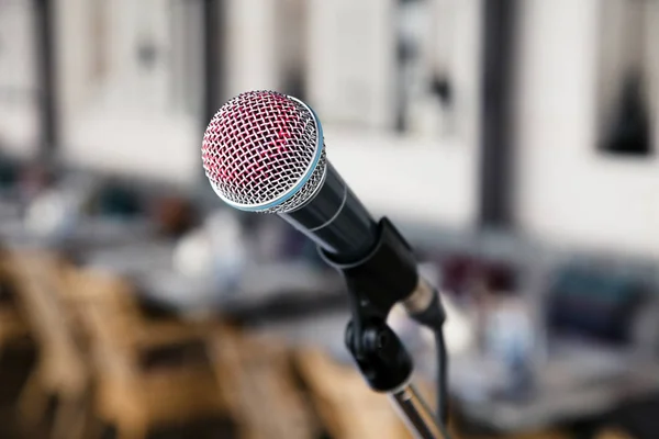 Closeup imprint of a red lipstick singer on a silver iron microphone on the stares on the stage. Concept live music in a restaurant or bar in the evening