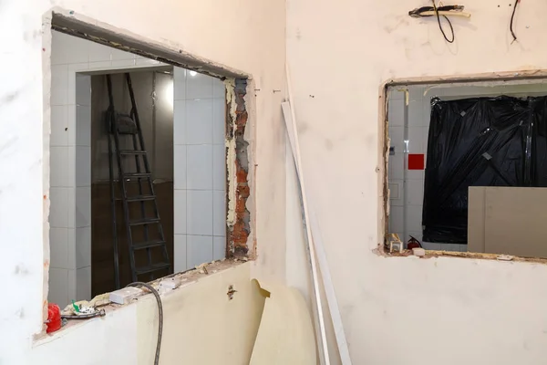Repair and replacement windows in office building, destroyed window partitions of bricks and tiles. Concept construction team, finishing works, redecoration, cabinet reconstruction, wall dismantling