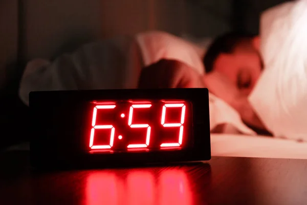 Alarm Clock Bedside Table Red Numbers Sleeping Man Bed Dark — Stock Photo, Image