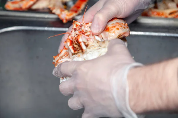 Cook chef is carving fresh red big boiled prepared blue kamchatk