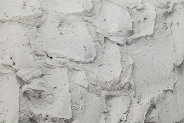 Doku arka planı. Sert dikişli gri beton duvar, havan topu,