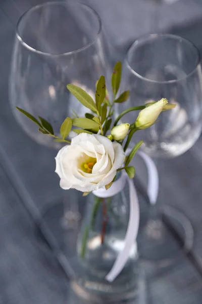 Modern restaurant setting, glass vase with bouquet flowers on ta
