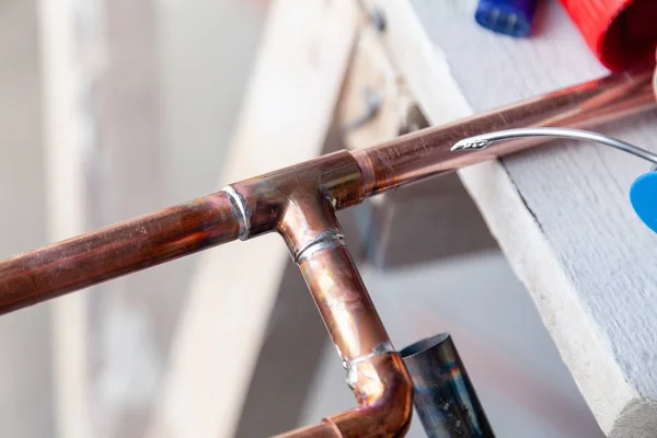Closeup professional soldering copper pipes gas burner. Concept