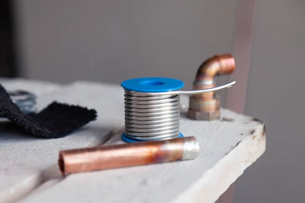 Closeup copper pipes, fittings, aluminum flux paste for solder f