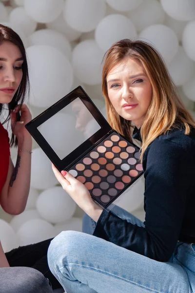 Makeup artist doing professional make up, applies eye shadows