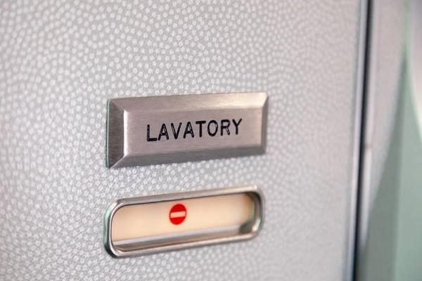 Vacant red sign, occupied symbol on an airplane lavatory door. R