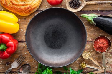 Pilaf malzemeleri, pirinç, sebzeler, pide, çatal bıçak, sade arka planda baharatlar.