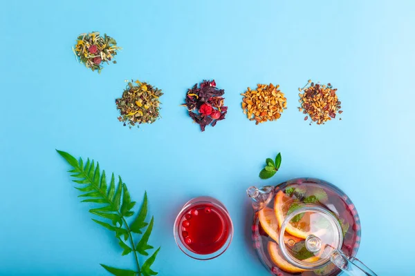 Fruit tea in teapot and tea in cup, piles of different tea — Stock Photo, Image