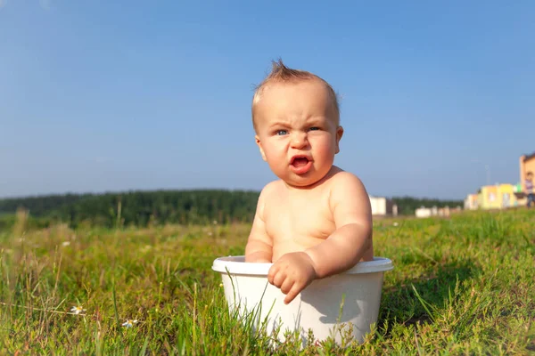 Cute sweet little blonde naked baby sitting in basin — Stock Photo, Image