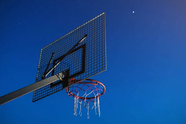 basketball basket with grid on blue sky background