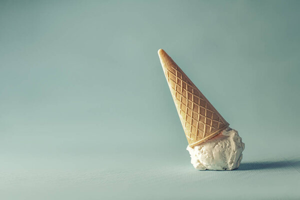 sweet white ice cream on pastel blue background