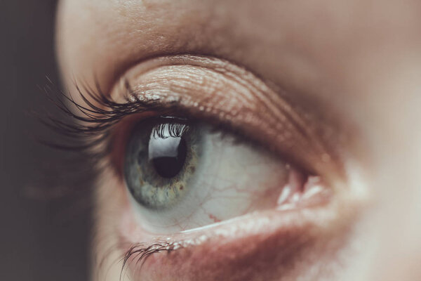 Close up of female eye and contact lens 