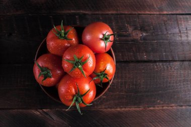 Ahşap arka plan üzerinde kırmızı, olgunlaşmış domates. Domates hasat. Üstten görünüm