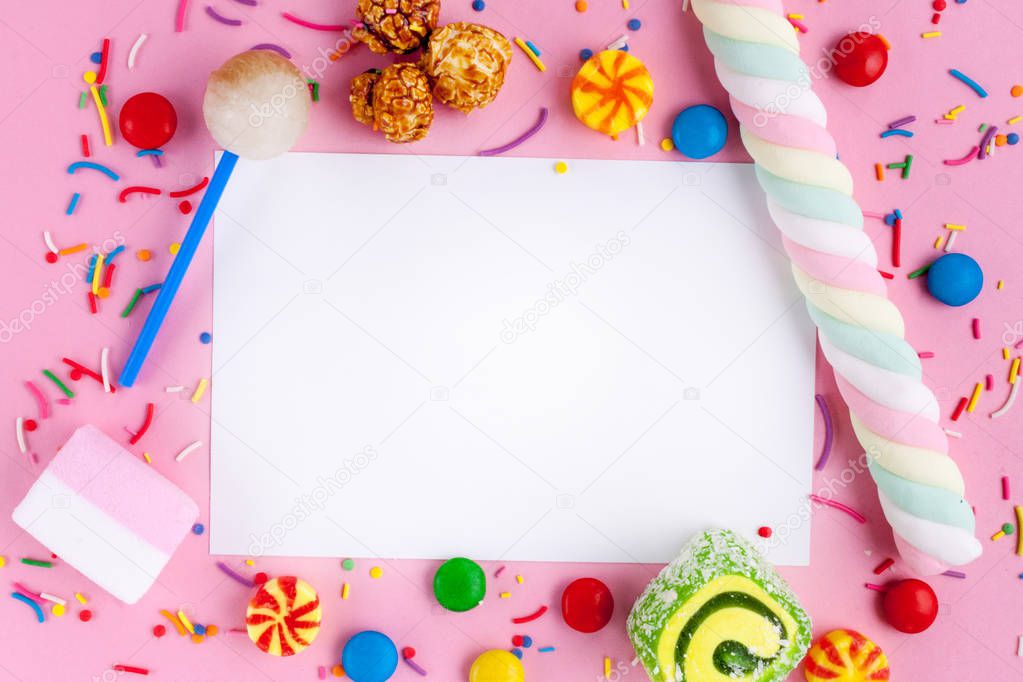 Frame for the text on the background of different, sugar, children's sweets. Candies on a pink background. Copy space, sweets concept