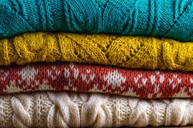 Ahşap arka plan üzerinde sıcak, örme, kış giysileri. Kış giysileri doku. Çirkin Noel kazağı 