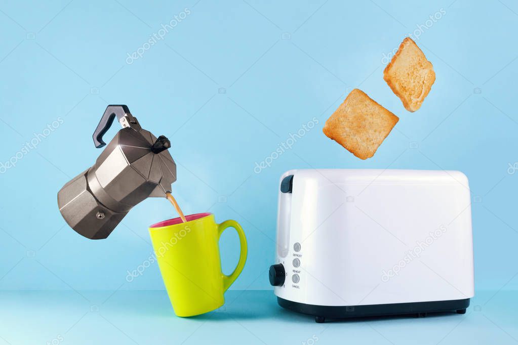 Good morning concept. A cup of hot, fresh coffee, a coffee maker and roasted toast bread popping up of toaster on a blue background. Wake up early in the morning for a delicious breakfast.