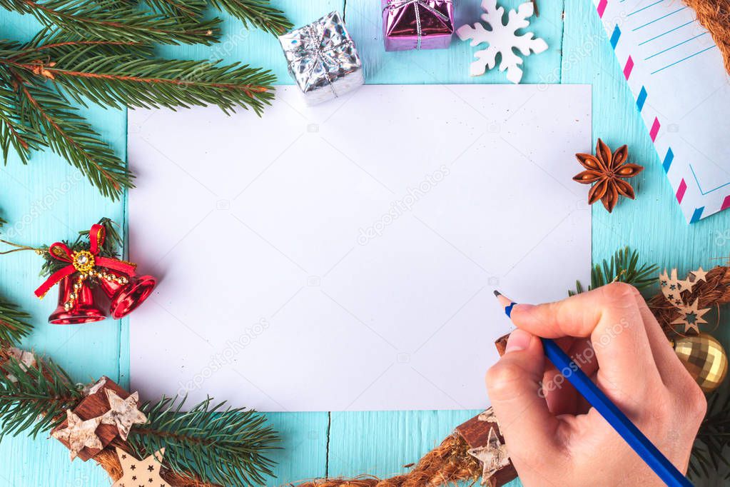 Christmas and New Year holidays. Writes congratulations on the Christmas card. Sending a congratulatory letter. Xmas. Copy space. Top view. Christmas flat lay. Letter to Santa Claus