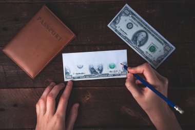 Kalpazan banknotlar uydurandan. Sahte kavramı. Sahte para, Amerikan 100 dolar, ahşap arka plan üzerinde bir pasaport